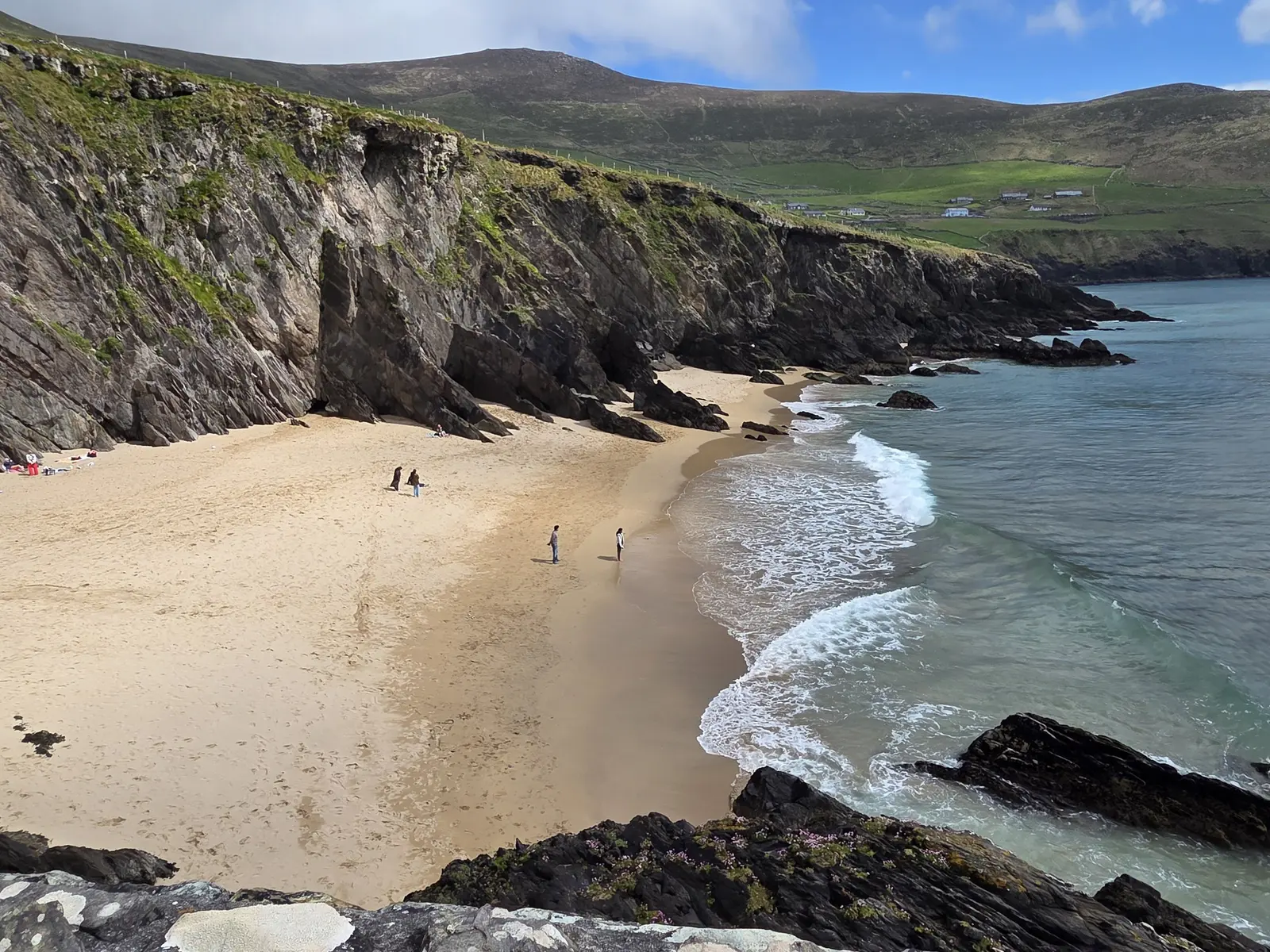 Coumeenoole beach on the Slea Head Drive, a curve of sand below dark cliffs