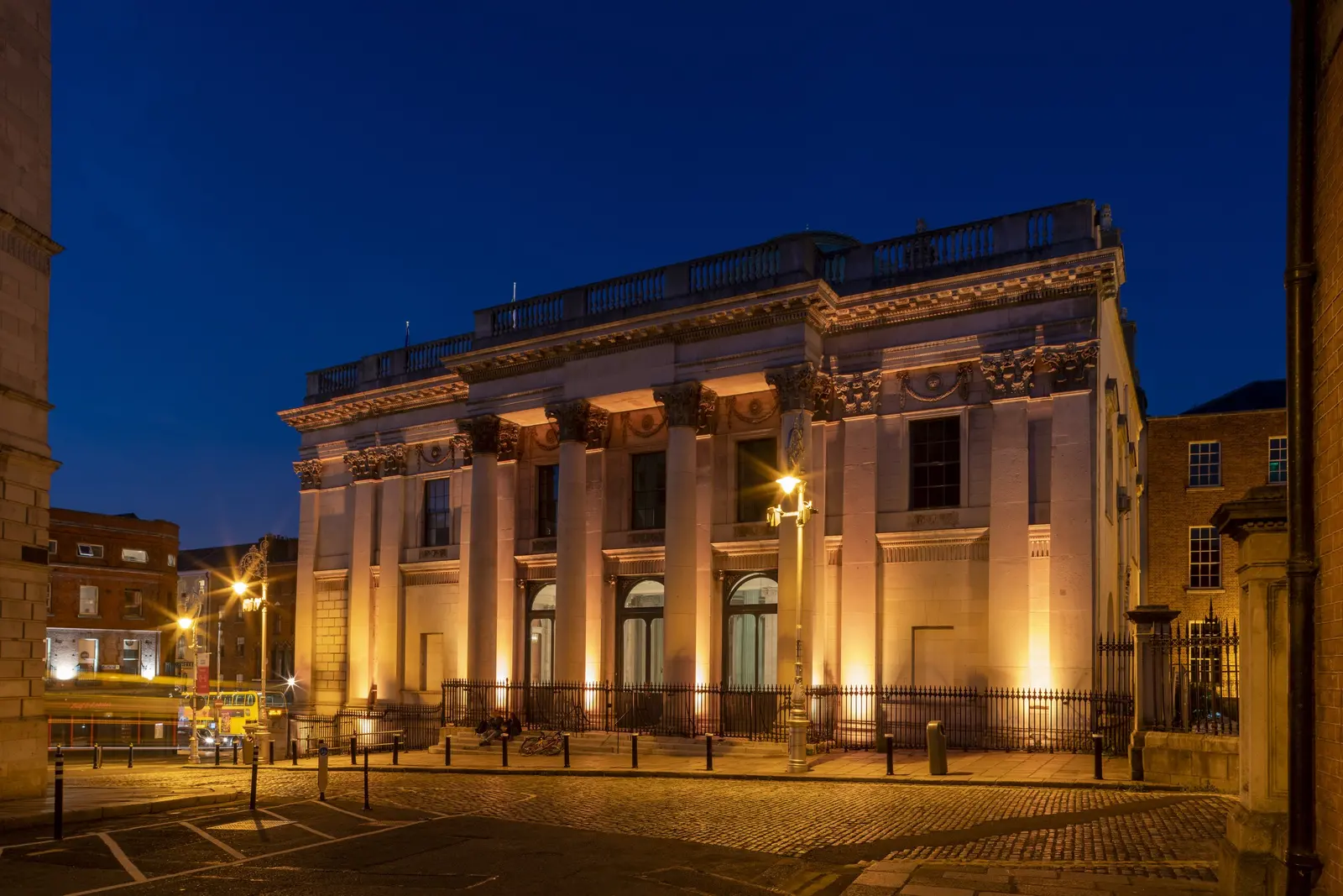 City Hall on Dame Street in Dublin lit against a deep blue evening sky