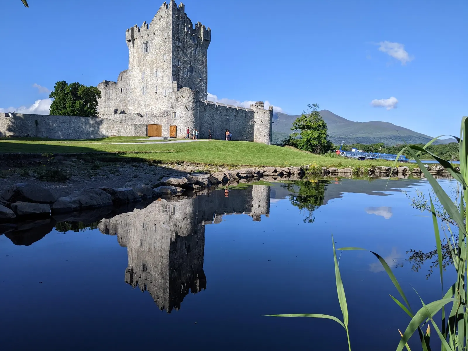 Ross Castle reflected in Lough Leane with the Macgillycuddy's Reeks behind it